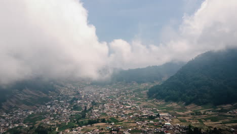 Aerial-hyperlapse-of-a-valley-in-Guatemala-surrounded-by-low-lying-clouds