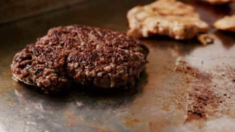 Close-up-of-a-delicious-hamburger-meat-cooking-on-a-metal-plate