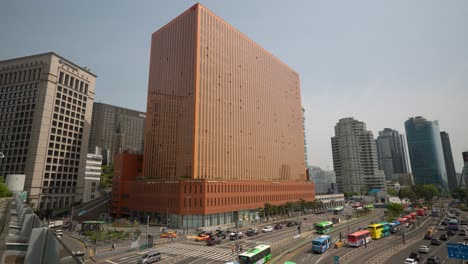 Edificio-Cuadrado-De-Seúl-Y-Autobuses-Ocupados-Que-Viajan-Por-La-Estación-Central-En-El-Centro-De-La-Ciudad-Durante-El-Día