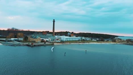 Engure,-Latvia,-23-May-2022:-Aerial-Drone-View-of-a-Corekites-Kitesurfers-Hydrofoiling-in-Engure-Port-at-in-Baltic-Sea