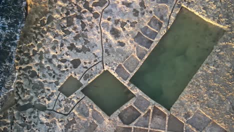 Aerial-shot-of-of-salt-pans-near-the-sea-in-the-Malta