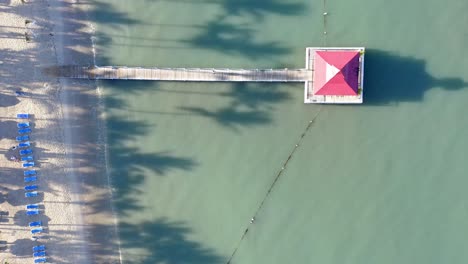 Overhead-drone-flight-at-a-La-Romana-resort-with-jetty-and-gazebo