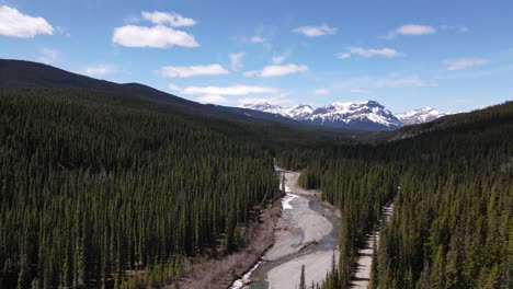 Aerial-View-Of-River-Near-Crescent-Falls-Alberta-Canada-With-Snow-Top-Mountains