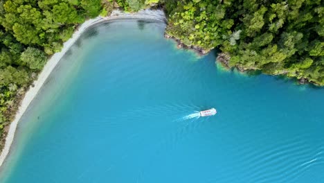 Overhead-view-of-a-boat-near-the-shore-of-Lake-Todos-Los-Santos-in-southern-Chile
