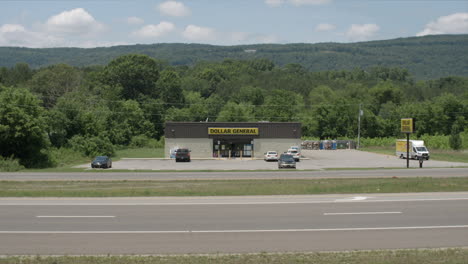 Wide-Dollar-General-Storefront-time-lapse-traffic-and-customers-arrive