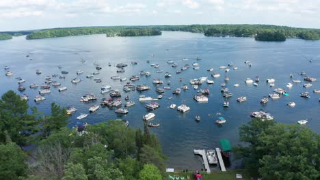 Aerial,-motor-boats-crowded-on-a-lake-during-college-spring-summer-break