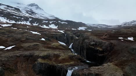 Scenic-Klifbrekkufossar-Waterfall-In-East-Iceland---aerial-pullback