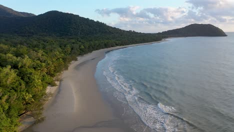 Cape-Tribulation-in-Daintree-Rainforest-overcast-aerial-of-empty-beach-and-palm-trees,-Queensland,-Australia