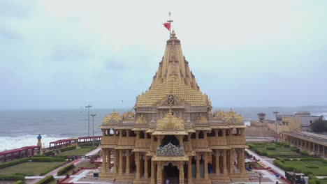 Aerial-drone-rising-shot-of-Somnath-mandir-during-evening-windy-time