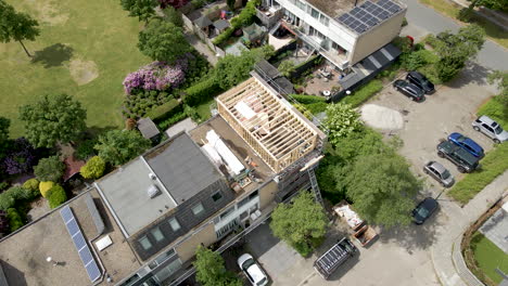 Aerial-overview-of-wooden-frame-of-roof-structure-under-construction-in-a-suburban-neighborhood