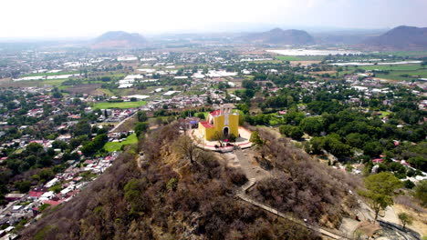 Orbital-drone-shot-of-church-on-top-of-hill-in-Atlixco-Mexico