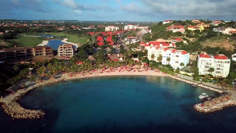 Aerial-view-dolly-in-tilt-down-of-Curacao's-Blue-Bay-beach,-Dutch-Caribbean-island,-golf-resort