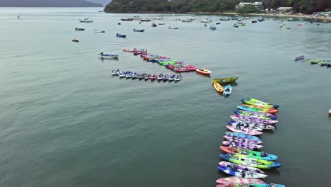 A-dynamic-orbiting-aerial-footage-of-various-boats-and-kayaks-near-the-beach-of-Sai-Kung-town-in-Hong-Kong