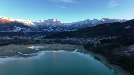 Drone-Aerial-view-of-lake-and-mountains-with-snow-in-winter