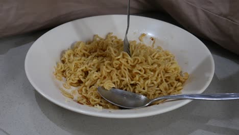 Instant-noodles-are-mixed-with-fork
