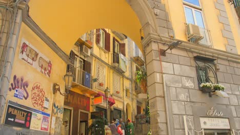 Tilting-down-European-style-architecture-in-Chiaia-district-with-gate,-windows-and-beautiful-balconies-in-Naples,-Italy