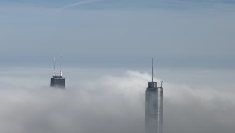 Two-Chicago-Skyscrapers-poking-out-above-low-fog-clouds