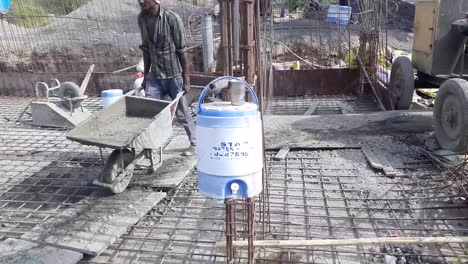 Construction-workers-use-a-concrete-Trolly-to-lay-concrete-on-a-steel-reinforced-concrete-structure-at-the-construction-site