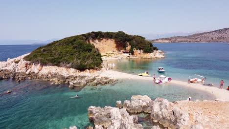 Tourist-People-Swim-and-Relax-at-Small-White-Sandy-Beach-at-Ksamil-Islands,-Albania