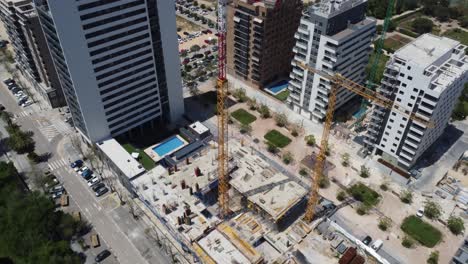 Top-down-view-of-a-Construction-site-between-Large-Apartment-Buildings
