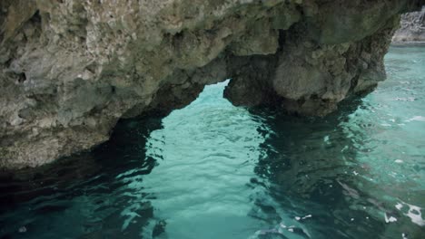 Beautiful-view-of-a-small-grotto-in-Capri,-in-Italy,-with-very-clear-and-transparent-water