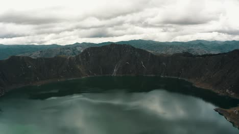 Quilotoa-Volcanic-Crater-Lagoon-With-Tourists-Enjoying-Scenery-In-Ecuador---aerial-drone-shot