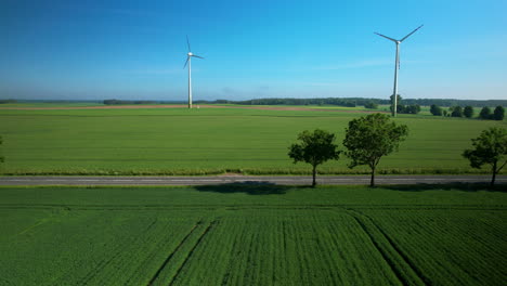 Wind-mills-turbines-spinning-in-the-wind-on-green-farm-land
