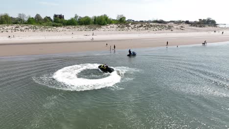 An-aerial-view-over-Gravesend-Bay-in-Brooklyn,-NY-as-a-jet-ski-rider-enjoys-the-beautiful-day