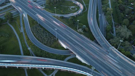 Timelapse-cinemagraph-loop-of-many-vehicles-crossing-a-freeway-intersection-after-sunset