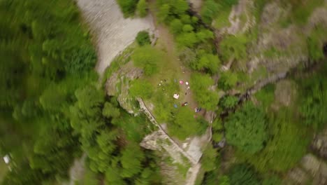 Vortex-with-a-drone-over-a-fir-forest-in-the-swiss-alps,-aerial-shot