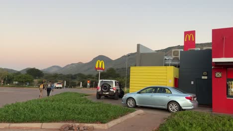 McAuto-service-in-rural-McDonald´s-at-sunset-in-Thabazimbi-village,-South-Africa