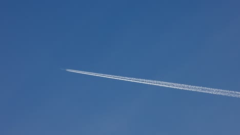 airplane-is-making-clouds-as-it-flies-over-the-blue-sky