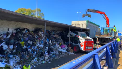 Big-garbage-trash-truck-crash-on-a-highway-being-cleared-up-by-emergency-response-vehicles-and-excavators-tractors-on-the-main-road-in-Marbella-Malaga-Spain,-dangerous-transport-accident,-news-story