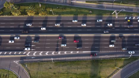 down-tilt-drone-shot-of-the-busy-general-paz-highway-at-sunset-in-buenos-aires-in-argentina