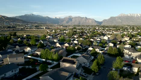 Single-family-homes-in-a-typical-suburban-neighborhood-in-a-valley-below-the-Rocky-Mountains---panoramic-parallax-aerial-view