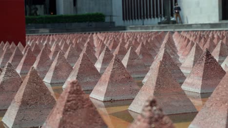 Low-Angle-View-Of-Small-Stone-Pyramids-At-Entrance-To-The-Museum-of-Tolerance-and-Memory-In-Mexico-City