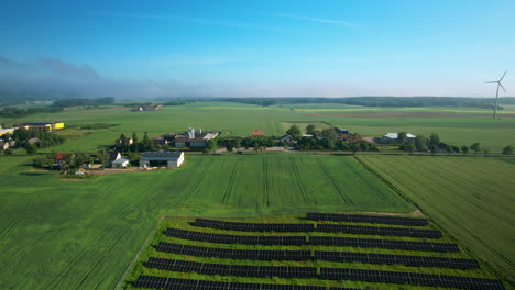 Solar-panel-farm-in-small-farm-town,-wind-mills,-farm-fields