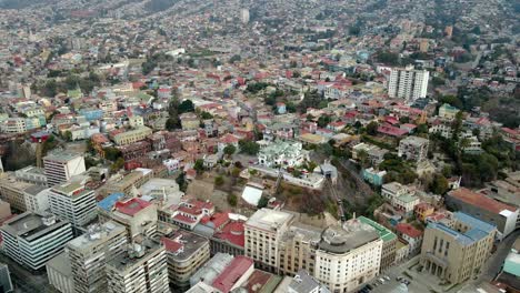 Aerial-dolly-in-of-Chilean-Army-building,-Baburizza-Palace,-Yugoslavian-Walk-and-El-Peral-funicular-in-Cerro-Alegre,-Valparaiso,-Chile