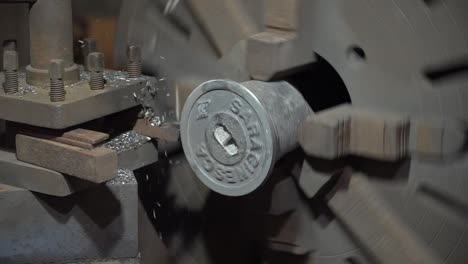 Industrial-metal-grinding-process-in-metal-casting-factory,-slow-motion-shot