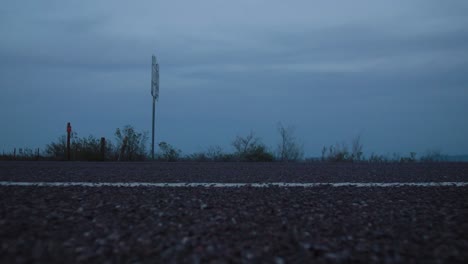 Car-Passes-on-Desert-Highway-at-Blue-Hour-4K-Left-to-Right-Dolly