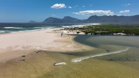 Extreme-jump-while-kite-surfing-near-coastline-of-South-Africa,-aerial-view