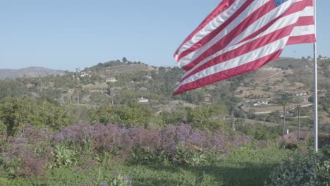 American-Flag-flying-high-over-Fallbrook,-California-Mountains
