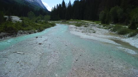 Aerial-view-from-a-drone-flight-over-the-wild-Leutascher-Ache-River,-located-in-Gais-Valley-in-Austria