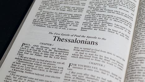 Close-Up-Shot-of-Bible-Page-Turning-to-the-book-of-First-Thessalonians