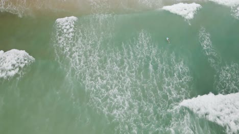 Waves-lapping-along-shoreline-of-Wrightsville-beach-Topdown-Aerial
