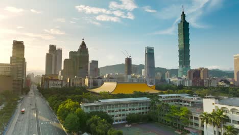Cinematic-aerial-shot-showing-Sun-Yat-Sen-Memorial-Hall-and-silhouette-of-skyscraper-towers-in-Taipei-City-during-sunset