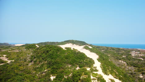 Scenic-landscape-of-white-sand-dunes-on-coast-of-Binh-Thuan-province,-Vietnam,-aerial