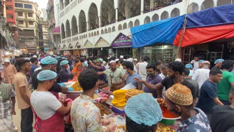 High-angle-shot-over-delicious-food-been-sold-in-an-old-traditional-Iftar-street-food-market-in-Dhaka,-Bangladesh