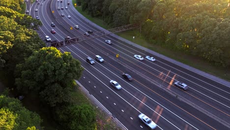 An-aerial-view-of-the-Southern-State-Parkway-during-a-golden-sunset-on-Long-Island,-NY