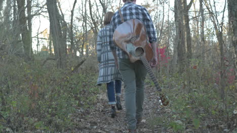 musicians-walking-in-the-woods,-low-angle,-slow-motion
